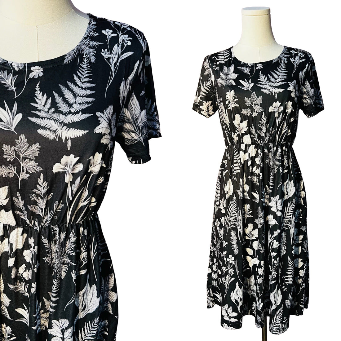 Two black dresses with white floral and leaf patterns on mannequins against a white background.